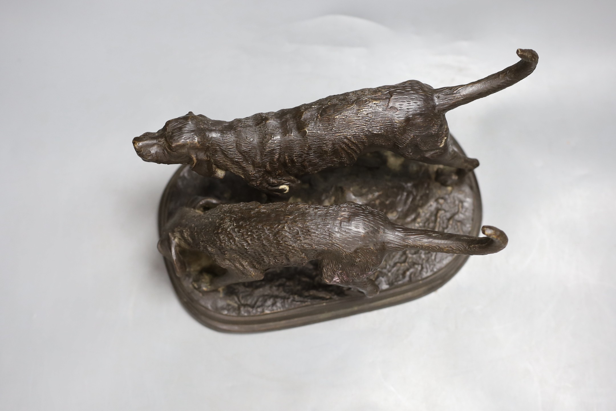 A bronze model of two hounds, 28cms wide
